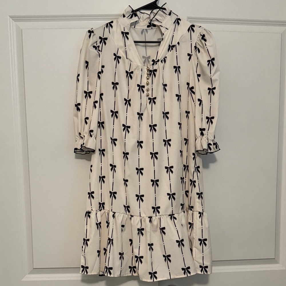 Chic White Dress with Black Bow Pattern